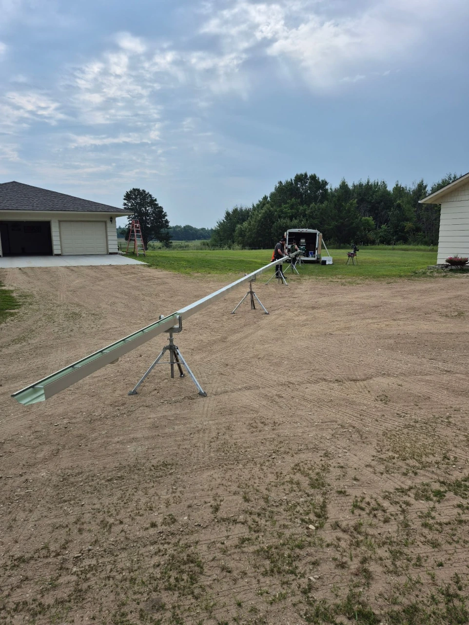 Gutter installation trench and drainage setup in International Falls