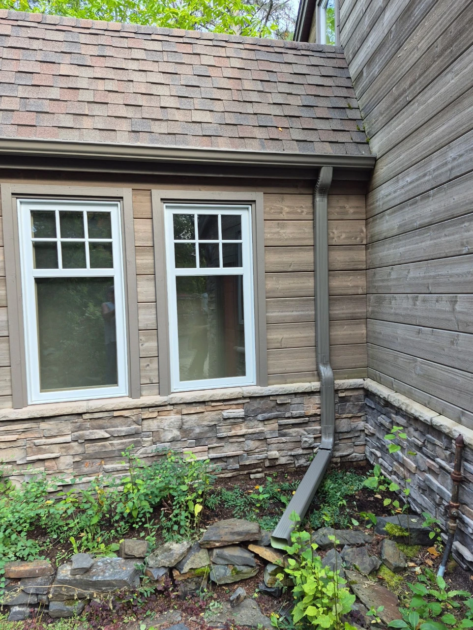 Gutter installation on home with multiple windows in International Falls
