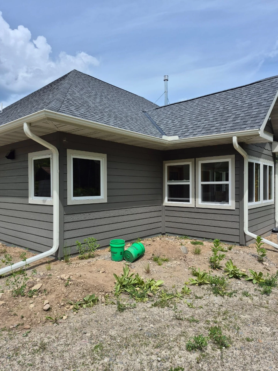 New seamless gutters installed on home exterior in International Falls