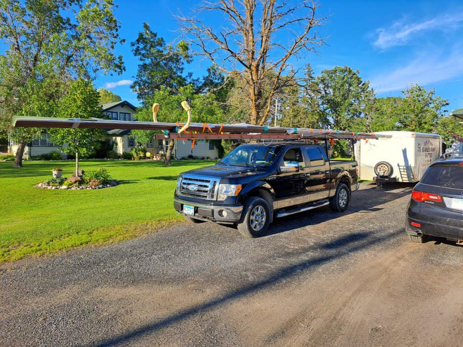 Gutter installation service truck on job site in International Falls