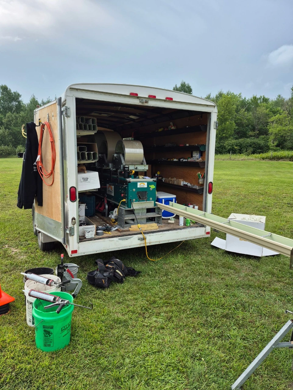 Gutter installation equipment and trailer setup on site in International Falls